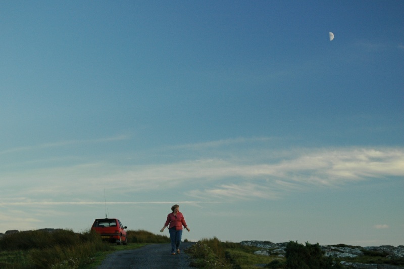 Diane Harrington and the first quarter moon, near Clifden, Ireland